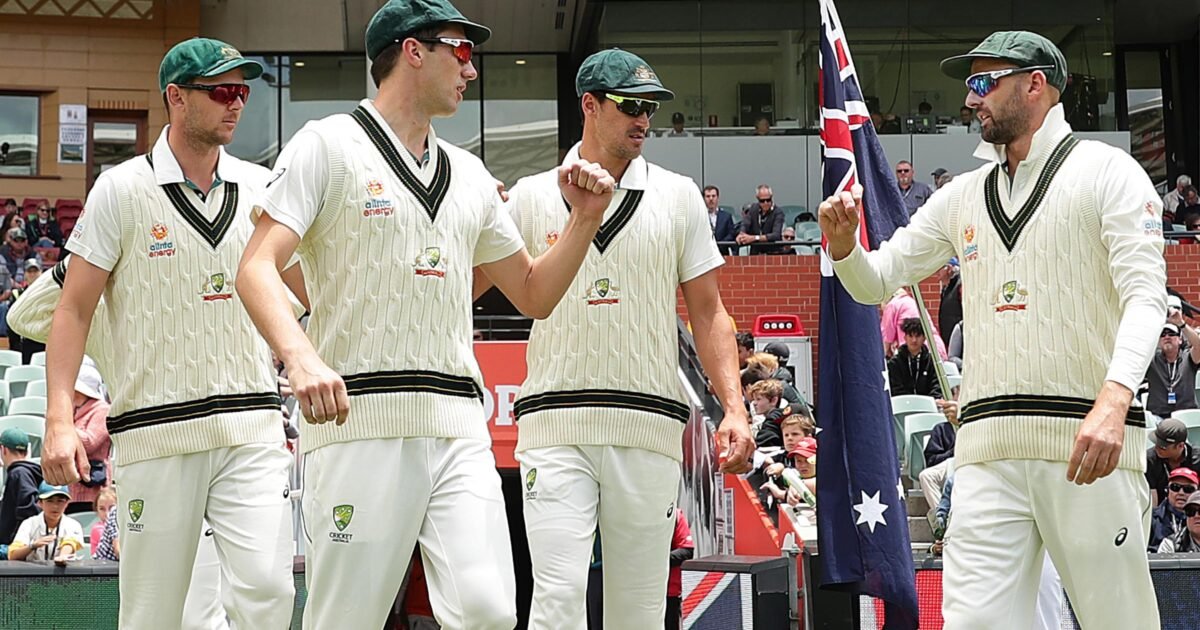 Australia Test cricketers walking out onto the field in whites