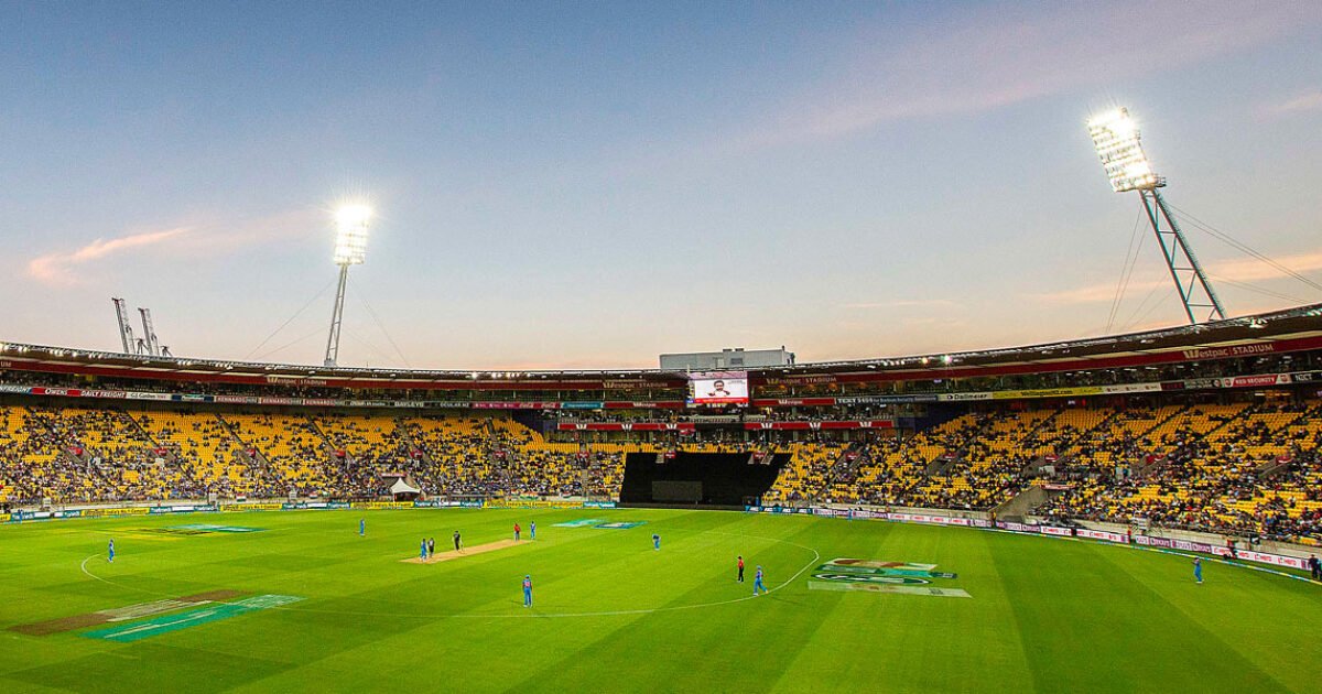 Hnry Stadium in Wellington lit up under floodlights during an evening T20 international, with players on the field