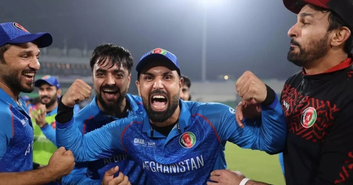Afghanistan players Mohammad Nabi and Rashid Khan celebrating a win in blue ODI kit