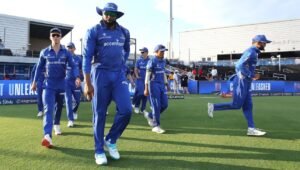 Kieron Pollard walking out with his Mumbai Indians team-mates